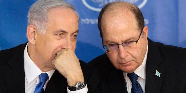 Feb. 16, 2015: Israeli Prime Minister Benjamin Netanyahu, left, speaks with Israel's Defense Minister Moshe Yaalon during a ceremony for new Israeli Chief of Staff Gadi Eizenkot at the Prime Minister's office in Jerusalem.