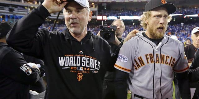 San Francisco Giants manager Bruce Bochy and Hunter Pence celebrate after Game 7 of baseball's World Series against the Kansas City Royals Wednesday, Oct. 29, 2014, in Kansas City, Mo. The Giants won 3-2 to win the series. (AP Photo/Charlie Neibergall)