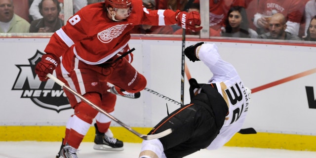 Detroit Red Wings left wing Justin Abdelkader (8) checks Anaheim Ducks defenseman Toni Lydman (32) during the second period in Game 3 of a first-round NHL hockey Stanley Cup playoff series in Detroit, Saturday, May 4, 2013. Abdelkader was ejected for the hit. (AP Photo/Detroit News, John T. Greilick) DETROIT FREE PRESS OUT; HUFFINGTON POST OUT