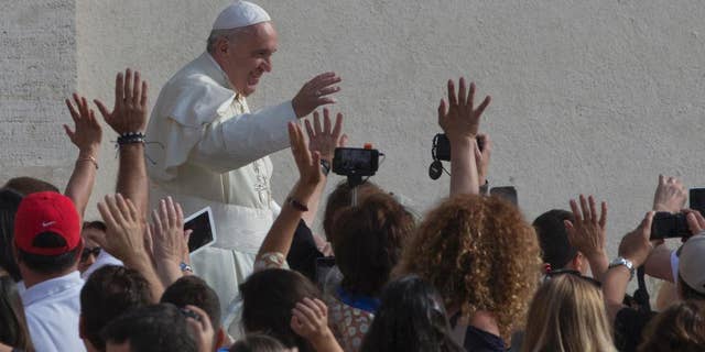 Pope Francis waves as he arrives for his weekly general audience in St. Peter's Square at the Vatican, Wednesday, Sept. 9, 2015. (AP Photo/Alessandra Tarantino)