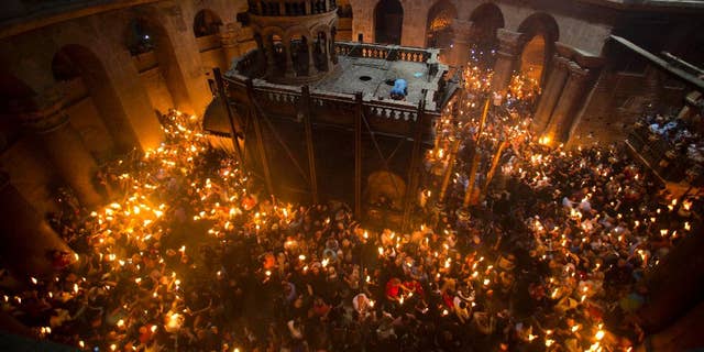 Christian Orthodox pilgrims hold candles during the Holy Fire ceremony in the Church of the Holy Sepulchre in Jerusalem, held each year on Holy Saturday. The Church of the Holy Sepulchre is believed to be the location of Jesus' death, burial, and resurrection.