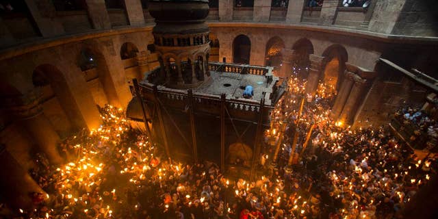 Christian Orthodox pilgrims hold candles during the Holy Fire ceremony in the Church of the Holy Sepulchre in Jerusalem, held each year on Holy Saturday. The Church of the Holy Sepulchre is believed to be the location of Jesus' death, burial, and resurrection.