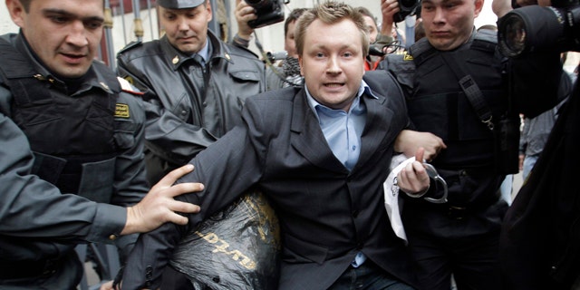 September 21: Police officers detain Russian gay rights activist Nikolai Alexeyev during a rally near city hall in Moscow. Mayor Yuri Luzhkov has called homosexuals "satanic" and routinely thwarted their attempts to hold a gay pride in Moscow. (AP)