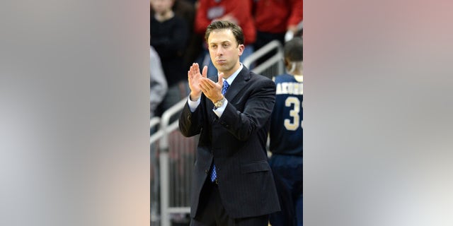 FILE - In this Dec. 19, 2012 file photo, Florida International coach Richard Pitino applauds his team's effort during the second half of an NCAA college basketball game against Louisville in Louisville, Ky. Minnesota is in advanced discussions with Richard Pitino, the son of Louisville coach Rick Pitino, to take over for Tubby Smith. Two people with knowledge of the discussions say Pitino engaged in negotiations with Minnesota officials on Wednesday, April 3, 2013. The people requested anonymity because the deal has not been formally completed. In his lone season at Florida International, Pitino led the Panthers to an 18-14 record, the school's first winning season in 13 years. (AP Photo/Timothy D. Easley, File)