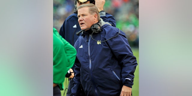 Notre Dame coach Brian Kelly talks to the officials in the first half of an NCAA college football game against Navy, Saturday, Nov. 2, 2013, in South Bend, Ind. (AP Photo/Joe Raymond)