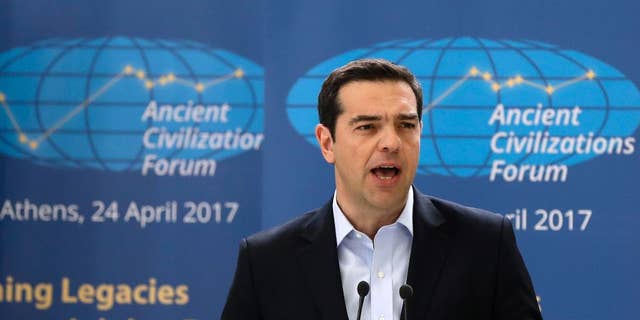 Greek Prime Minister Alexis Tsipras delivers a speech during the "Ancient Civilizations Forum" (ACForum) at Zappeio Conference Hall in Athens, Monday, April 24, 2017. Foreign Ministers and top officials from various countries attended the forum being held in the Greek capital. (AP Photo/Thanassis Stavrakis)