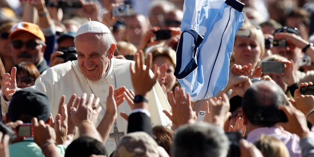 Pope Francis greets faithful upon arrival for his weekly general audience in St. Peter's Square at the Vatican, Wednesday, Sept. 18, 2013.