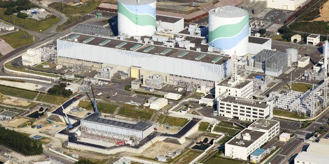 FILE - This Oct. 24, 2014 aerial photo shows two reactors at the Sendai Nuclear Power Station in Satsumasendai, Kagoshima prefecture, southern Japan. The nuclear plant on Wednesday, May 27, 2015 obtained the final permit needed to restart its reactors, paving the way for it to become the first to go back online under new safety standards introduced following the 2011 Fukushima disaster. The two reactors at the nuclear power station would mark the country’s return to nuclear energy, as Prime Minister Shinzo Abe’s pro-business government tries to put as many reactors back on-line as possible. (Kyodo News via AP, File) JAPAN OUT, CREDIT MANDATORY