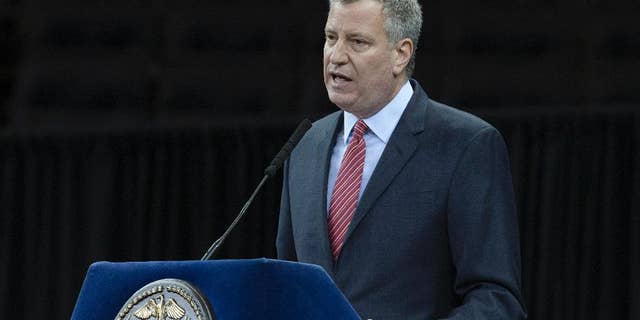 File-This Dec. 29, 2014, file photo shows New York City Mayor Bill de Blasio speaking during a New York Police Academy graduation ceremony at Madison Square Garden in New York. In the aftermath of last month’s terror attacks in Paris, New York City not only bolstered security but quietly stepped up outreach efforts to its Muslim community. It aimed to calm fears about any hate-filled retaliation while trying to extend government services to a community that often has felt neglected. (AP Photo/John Minchillo, File)