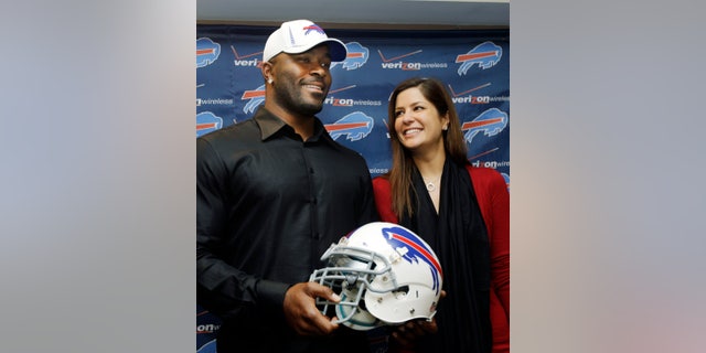 FILE - In this March 15, 2012 photo, Buffalo Bills' Mario Williams poses for a photo with his fiancee Erin Marzouki smile after an NFL football news conference in Orchard Park, N.Y. Here's one thing that can happen when love goes bad: Bills defensive end Mario Williams is suing his ex-fiancee, demanding she return a $785,000 diamond engagement ring. In response, Marzouki has filed a countersuit, calling Williams' demands "ridiculous." (AP Photo/David Duprey, File)