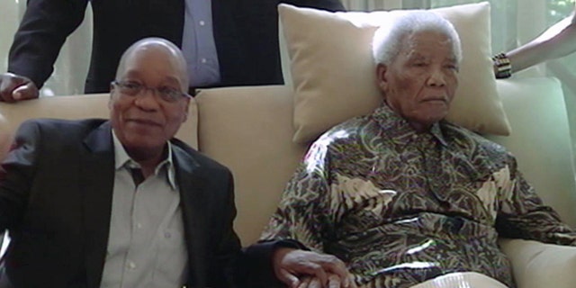 April 29, 2013: In this image taken from video, South African President Jacob Zuma, left, sits with the ailing anti-apartheid icon Nelson Mandela is filmed more than three weeks after being released from hospital.
