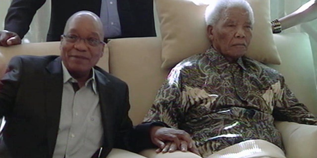 April 29, 2013: In this image taken from video, South African President Jacob Zuma, left, sits with the ailing anti-apartheid icon Nelson Mandela is filmed more than three weeks after being released from hospital.