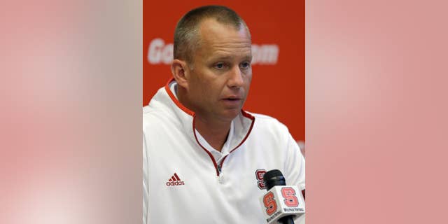 North Carolina State coach Dave Doeren speaks with reporters during an NCAA football media day in Raleigh, N.C., Sunday, Aug. 10, 2014. (AP Photo/Gerry Broome)