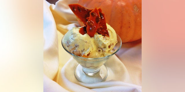Homemade bourbon ice cream, mixed with chunks of pumpkin roasted with brown sugar and cloves, is garnished with light, crunchy pieces of pepita brittle.