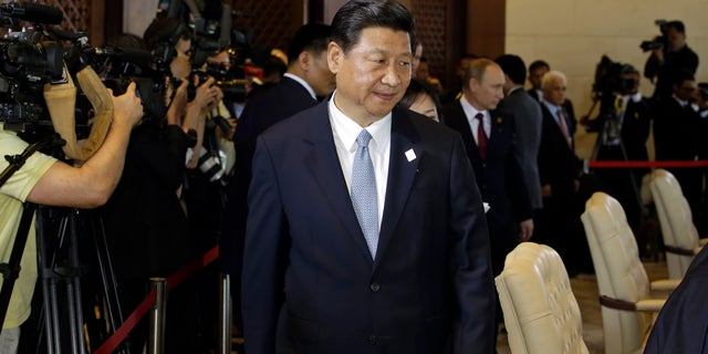 Chinese President Xi Jinping arrives to attend the Leaders Retreat during the Asia-Pacific Economic Cooperation (APEC) forum in Bali, Indonesia, Monday, Oct. 7, 2013. Pressure is mounting on Taiwan's weakened president to open political talks with Beijing after Jinping told a former senior Taiwanese official that the longstanding division between the sides should not be strung out indefinitely. China insists that the democratic island be brought under its control, and has threatened force to achieve that goal. The two sides split after a civil war in 1949. (AP Photo/Dita Alangkara)