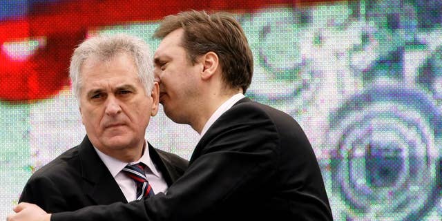 In this April 16, 2011 photo, Serbian Prime Minister Aleksandar Vucic, right, speaks with Serbian President Tomislav Nikolic during a protest rally in Belgrade, Serbia. Nikolic has lashed out against the outgoing U.S. administration expressing hope President-elect Donald Trump will be more favourable toward Serbia and its Russia-backed claim over Kosovo. (AP Photo/Darko Vojinovic)