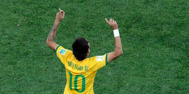Brazil's Neymar celebrates scoring his side's first goal during the group A World Cup soccer match between Brazil and Croatia, the opening game of the tournament, in the Itaquerao Stadium in Sao Paulo, Brazil, Thursday, June 12, 2014. (AP Photo/Shuji Kajiyama)
