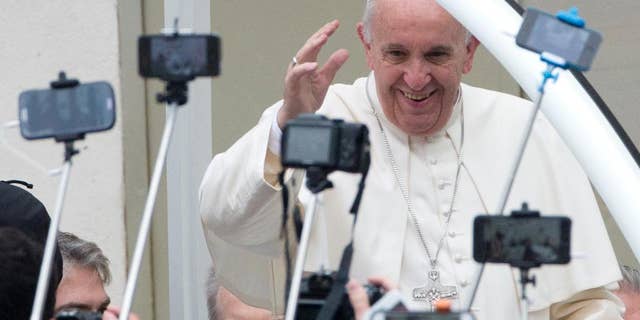 Pope Francis arrives for his weekly general audience in St. Peter's Square at the Vatican, Wednesday, Oct. 28, 2015. (AP Photo/Alessandra Tarantino)