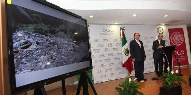 FILE - In this Dec. 7, 2014, file photo, Mexico's Attorney General, Jesus Murillo Karam, right, flanked by Tomas Zeron director of Mexico's Criminal Investigation Agency, speaks during a news conference in Mexico City. The Attorney General’s Office has announced on Wednesday, Sept. 14, 2016, the resignation of Tomas Zeron, whose dismissal had been demanded by the families of 43 college students who disappeared two years ago. (AP Photo/Marco Ugarte, File)