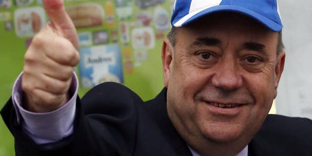 FILE - In this Thursday, Sept. 18, 2014 file photo, Scotland's First Minister Alex Salmond meets members of the public on a walkabout in Newmachar, Scotland. Scotland's former pro-independence leader, Alex Salmond, says he is going to run for a seat in the British Parliament in May's election. Salmond announced Sunday, Dec. 7, 2014 that he will contest a northeast Scotland seat for the Scottish National Party, which he led until last month. (AP Photo/Scott Heppell, File)