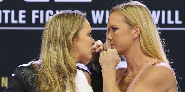 MELBOURNE, AUSTRALIA - SEPTEMBER 16:  UFC Women's Bantamweight Champion Ronda Rousey (L) faces off against Holly Holm during the UFC 193 media event at Etihad Stadium on September 16, 2015 in Melbourne, Australia.  (Photo by Michael Dodge/Zuffa LLC/Zuffa LLC via Getty Images)