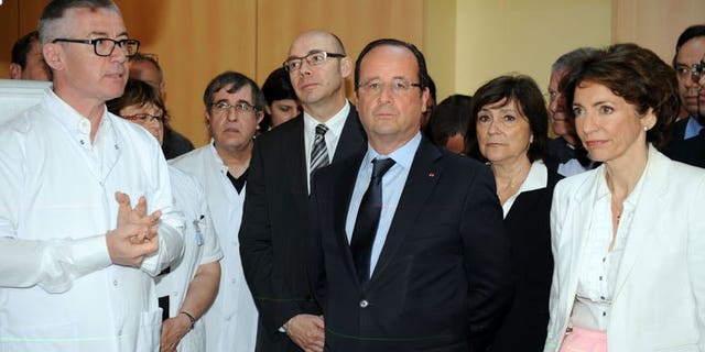 French President Francois Hollande (centre) visits the Bretagne Sud hospital in Brest, western France, on July 1, 2013. Hollande has told the United States to immediately cease spying on European institutions, after reports of covert US surveillance of EU diplomatic missions.
