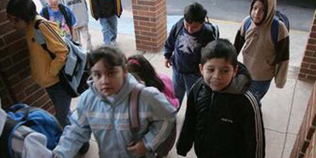 ** ADVANCE FOR WEEKEND OF MARCH 19-20 **Students make their from their buses to school at the Lyman Hall Elementary school in Gainesville, Ga., Wednesday, Feb. 23, 2005. Lyman Hall Elementary is listed as 94 percent Hispanic. (AP Photo/Ric Feld)