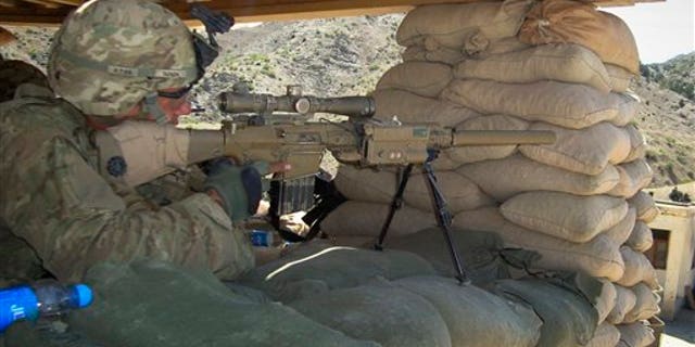 April 30: A U.S. soldier with the 1st battalion 3rd brigade and 1st infantry division monitors the area through the scope of his weapon at a check post of a joint U.S. and Afghan security forces base in Musa khel, district of Khost province southeast of Kabul, Afghanistan. (AP)
