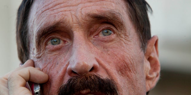 Software company founder John McAfee, here in a 2012 file photo, says his "enemies" spiked something he ingested.