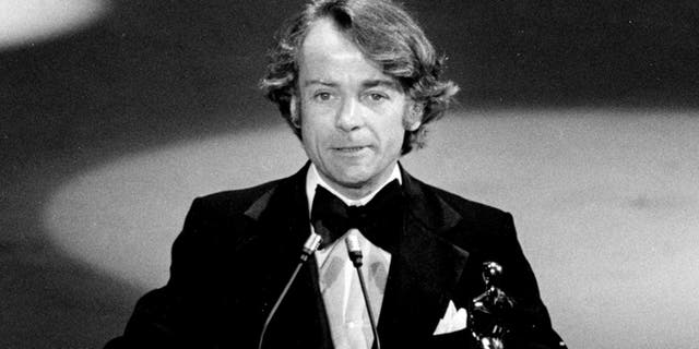 March 28, 1977, file photo, John G. Avildsen accepts the Oscar for best director for "Rocky" at the Academy Awards in Los Angeles. 