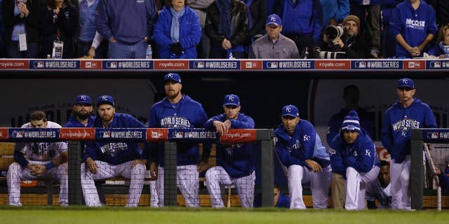 Kansas City Royals players watch from their dugout the seventh inning of Game 7 of baseball's World Series against the San Francisco Giants Wednesday, Oct. 29, 2014, in Kansas City, Mo. (AP Photo/Charlie Neibergall)