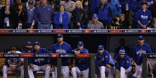 Kansas City Royals players watch from their dugout the seventh inning of Game 7 of baseball's World Series against the San Francisco Giants Wednesday, Oct. 29, 2014, in Kansas City, Mo. (AP Photo/Charlie Neibergall)