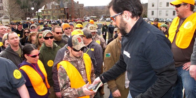 Rob Curtis, executive editor of a firearms magazine, handed out 30-round magazines at a gun rights event outside the Vermont Statehouse in Montpelier, Vt., on March 31 to oppose gun restriction legislation approved by state lawmakers.