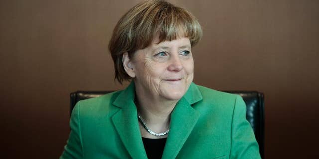 German Chancellor Angela Merkel smiles at the beginning of the weekly cabinet meeting of her government at the chancellery in Berlin, Wednesday, Jan. 28, 2015. (AP Photo/Markus Schreiber)