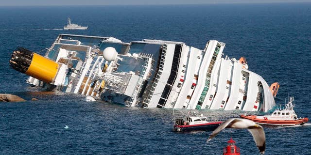 The luxury cruise ship Costa Concordia lays on its side after running aground the tiny Tuscan island of Giglio, Italy. (AP Photo/Gregorio Borgia)