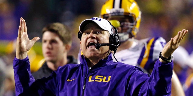 FILE - In this Nov. 23, 2013, file photo, LSU head coach Les Miles reacts to a touchdown call for Texas A&M that was later overturned on replay during the second half of an NCAA college football game in Baton Rouge, La. Recruiting is the lifeline of college coaches and with teenagers using social media like Twitter to communicate, some football staffs have pushed the boundaries of NCAA regulations to reach top high school recruits. Miles was reminded by LSU administration officials to use caution when taking to Twitter to discuss recruiting. National Signing Day is Wednesday, Feb. 5. (AP Photo/Gerald Herbert, File)