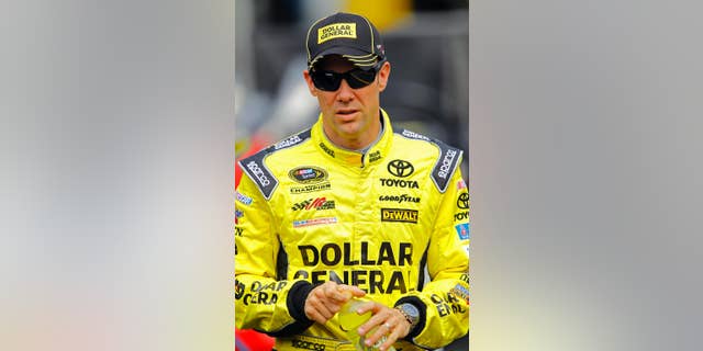 Matt Kenseth walks through the pit area during practice for a NASCAR Sprint Cup Series auto race at Bristol Motor Speedway on Friday, April 17, 2015, in Bristol, Tenn. Kenseth will start on the pole Sunday. (AP Photo/Wade Payne)