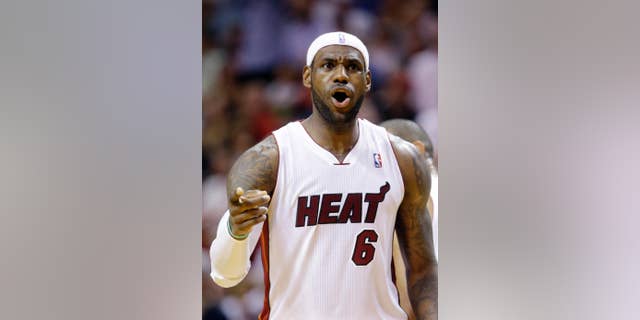 Miami Heat forward LeBron James celebrates after scoring during the second half of an NBA basketball game against the New York Knicks, Sunday, April 6, 2014, in Miami. James scored 38 points as the Heat defeated the Knicks 102-91. (AP Photo/Wilfredo Lee)