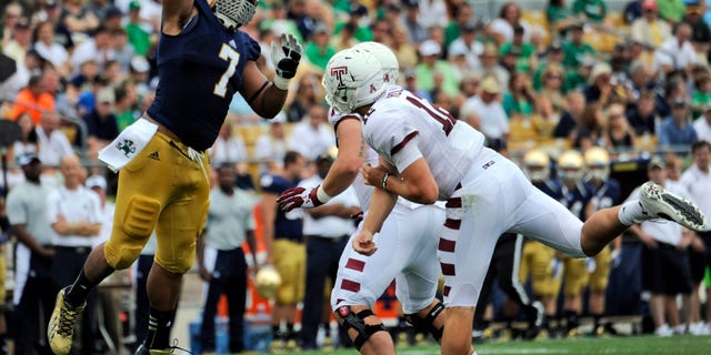 In this Aug. 31, 2013 photo, Notre Dame defensive lineman Stephon Tuitt (7) pressures Temple quarterback Connor Reilly, right, during a college football game in South Bend, Ind. Tuitt feels as comfortable playing the option as getting after quarterbacks, which is why he will be in the center of things against Air Force on Saturday, Oct. 26. (AP Photo/Joe Raymond)