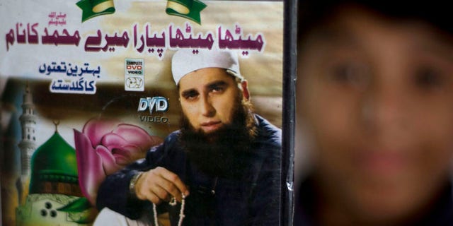 FILE - In this Dec. 3, 3014 file photo, a vendor shows a DVD of Pakistan's Junaid Jamshed at a stall in Islamabad, Pakistan. A plane belonging to Pakistan's national carrier crashed on Wednesday with about 42 passengers and five crew members and an engineer on board, apparently killing all of them, police and an airline spokesman said on Wednesday, Dec. 7, 2016. Authorities have released names of passengers -- among them Junaid Jamshed, a famous singer-turned-Islamic-preacher. (AP Photo/B.K. Bangash, File).