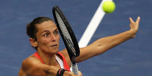 FILE -- In this Sept. 12, 2015 file photo, Roberta Vinci, of Italy, returns a shot to Flavia Pennetta, of Italy, during the women's championship match of the U.S. Open tennis tournament in New York. Seven months after ending Serena Williams' bid for a calendar-year Grand Slam in the semifinals of the U.S. Open, Vinci will be the local favorite at the Italian Open this week. (AP Photo/Seth Wenig)
