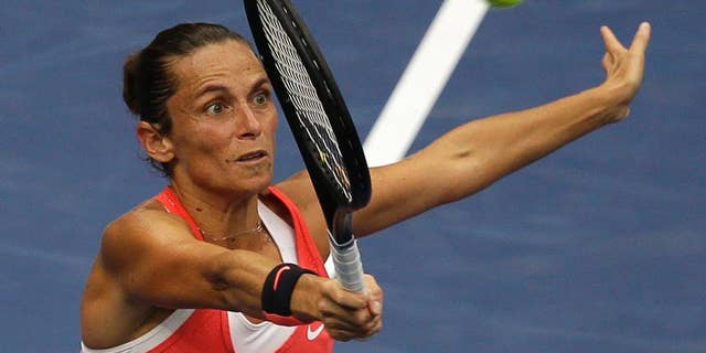 FILE -- In this Sept. 12, 2015 file photo, Roberta Vinci, of Italy, returns a shot to Flavia Pennetta, of Italy, during the women's championship match of the U.S. Open tennis tournament in New York. Seven months after ending Serena Williams' bid for a calendar-year Grand Slam in the semifinals of the U.S. Open, Vinci will be the local favorite at the Italian Open this week. (AP Photo/Seth Wenig)