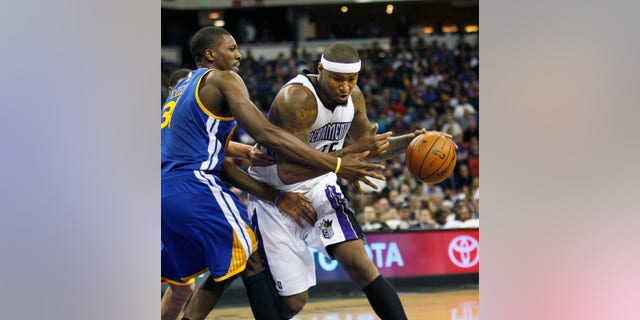 Sacramento Kings center DeMarcus Cousins, right, drives to the basket around Golden State Warriors defender Festus Ezeli during the second half of an NBA basketball game in Sacramento, Calif., on Wednesday, Dec. 19, 2012. The Kings won 131-127.(AP Photo/Steve Yeater)
