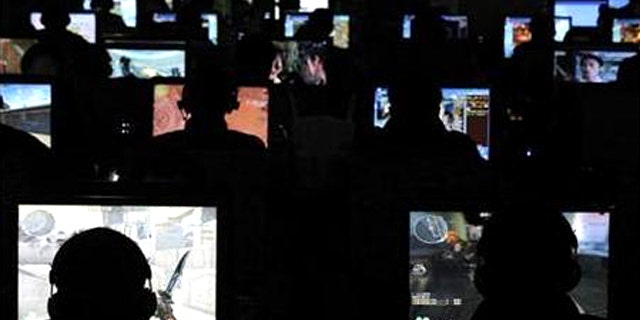 People use computers at an Internet cafe in Taiyuan, Shanxi province, November 13, 2009.