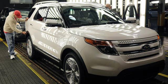 In this Oct. 22, 2014 photo, workers perform final inspections on 2015 Ford Explorers on the assembly line at the Chicago Ford Assembly Plant in Chicago. The Commerce Department releases its January report on durable goods on Thursday, Feb. 26, 2015. (AP Photo/M. Spencer Green)