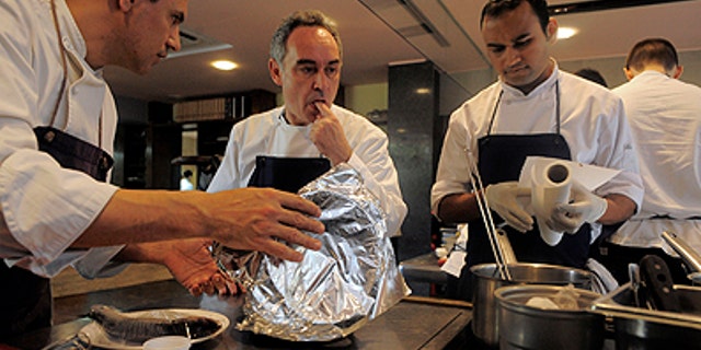 This March 30, 2011 photo shows Spanish chef Ferran Adria as he tastes some food in the kitchen of his restaurant elBulli in Roses, Spain. The oft-imitated, modernist wizardry that Adria has pioneered for nearly 20 years in Spain's far northeastern tip has earned him fame, awards and the highest of honors. (AP Photo/Manu Fernandez)