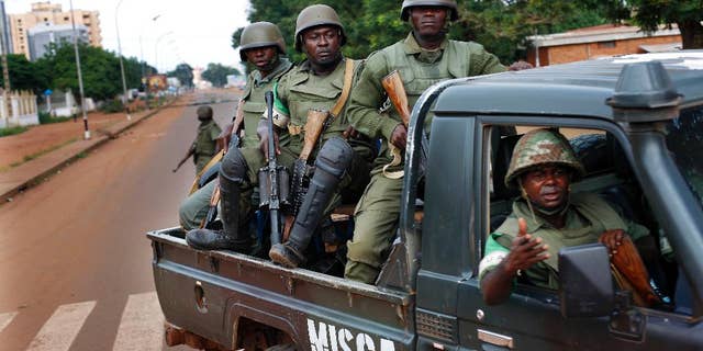 FILE-In this file photo taken on Thursday, May 29, 2014, African Union MISCA troops from Cameroon patrol in Bangui, Central African Republic. The United Nations took over a regional African peacekeeping mission in Central African Republic on Monday, Sept. 15, nine months after sectarian violence erupted that has left at least 5,000 people dead and has forced tens of thousands of Muslims to flee into exile in neighboring countries. (AP Photo/Jerome Delay,File)