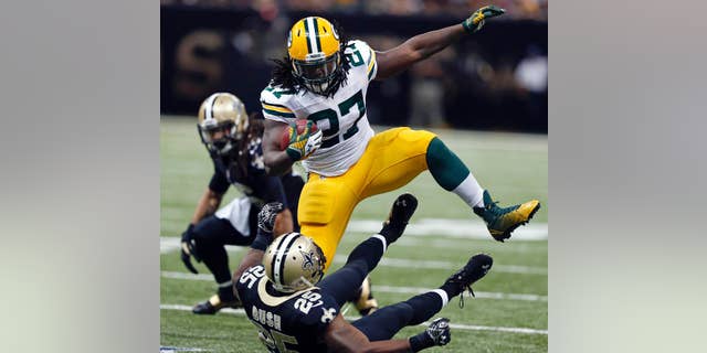 FILE - In this Oct. 26, 2014, file photo, Green Bay Packers running back Eddie Lacy (27) carries over fallen New Orleans Saints free safety Rafael Bush (25) in the second half of an NFL football game in New Orleans. Lacy is rolling over defenders. Aaron Rodgers is rolling in general. The Packers have climbed into a first-place tie in the NFC North by winning six of their last seven games. (AP Photo/Rogelio Solis, File)