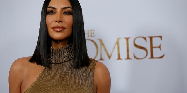 Television personality Kim Kardashian poses at the premiere of