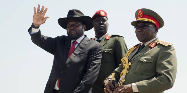 FILE - In this Thursday, July 9, 2015 file photo, South Sudan's President Salva Kiir, left, accompanied by army chief of staff Paul Malong, right, waves during an independence day ceremony in the capital Juba, South Sudan. A spokesman said Wednesday, Feb. 8, 2017 that Kiir will seek election next year, in what will be the first vote on Salva Kiir's leadership since the turbulent country won independence. (AP Photo/Jason Patinkin, File)